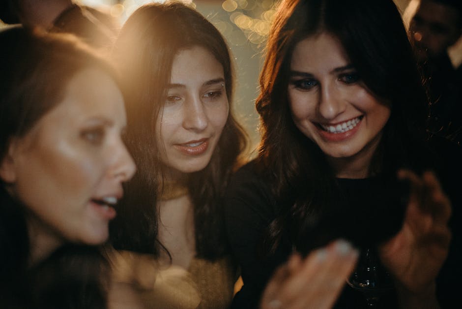 A diverse group of people of different ages smiling and looking relaxed indoors.